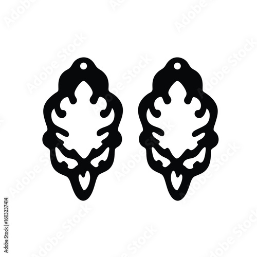 Black ornate earring mold shapes white background