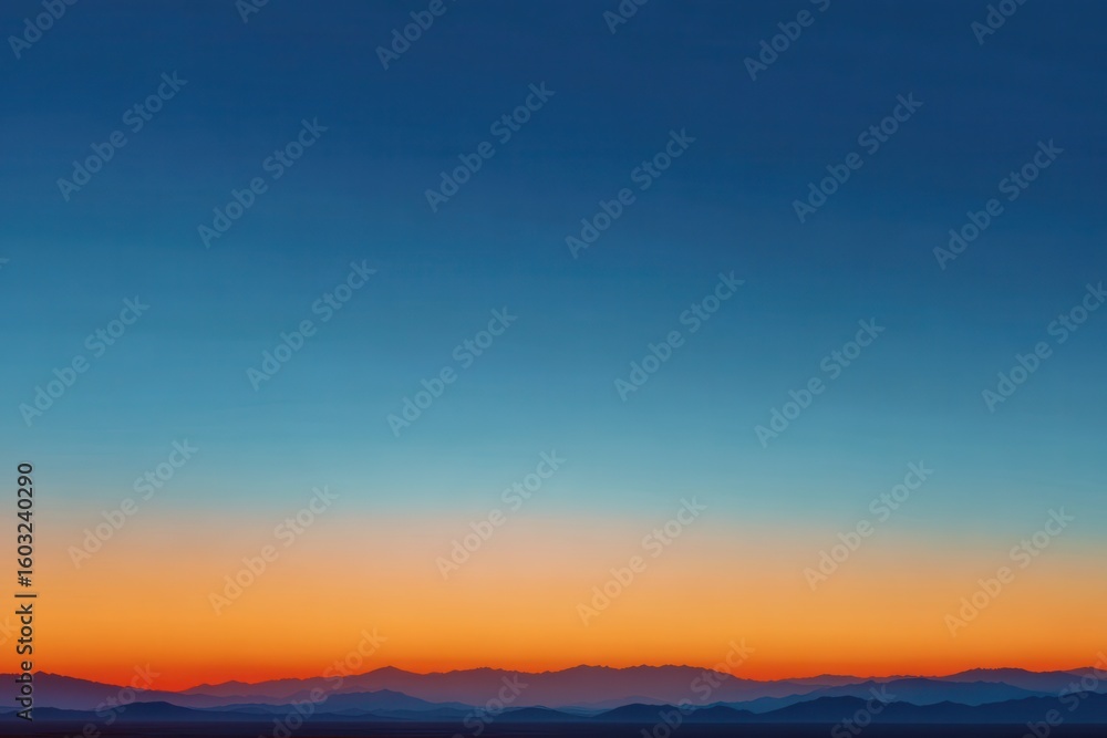 Obraz premium Orange Gradient Sunset Beneath Blue Sky