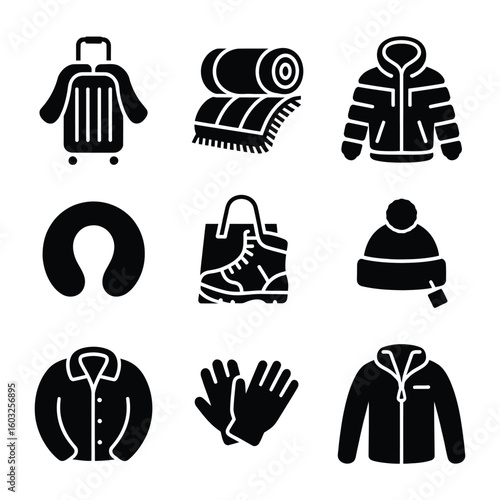 Winter travel essentials including suitcase coat scarf and foldable jacket