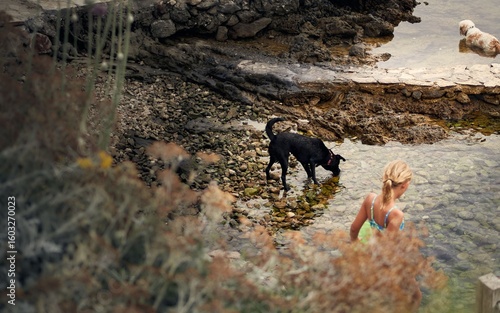 Photography Woman with dogs on Croatia's rocky shoreline