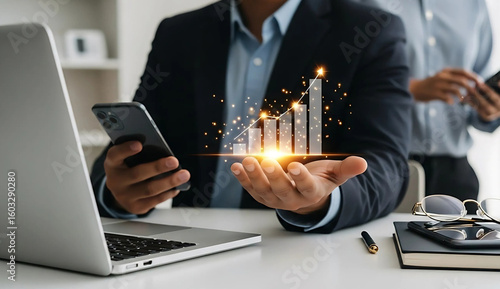 Businessman holding virtual graph with rising arrow symbolizing business success and financial growth