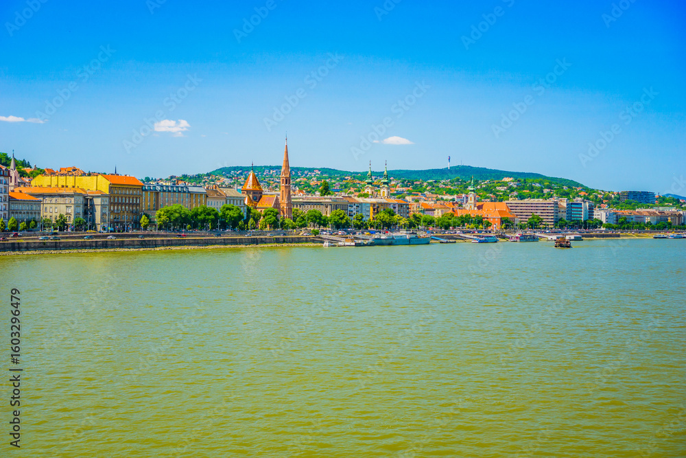 Obraz premium Panoramic view of the budapest cityscape and danube river on a sunny day with clear blue sky, concept of travel agencies, tourism boards, urban exploration