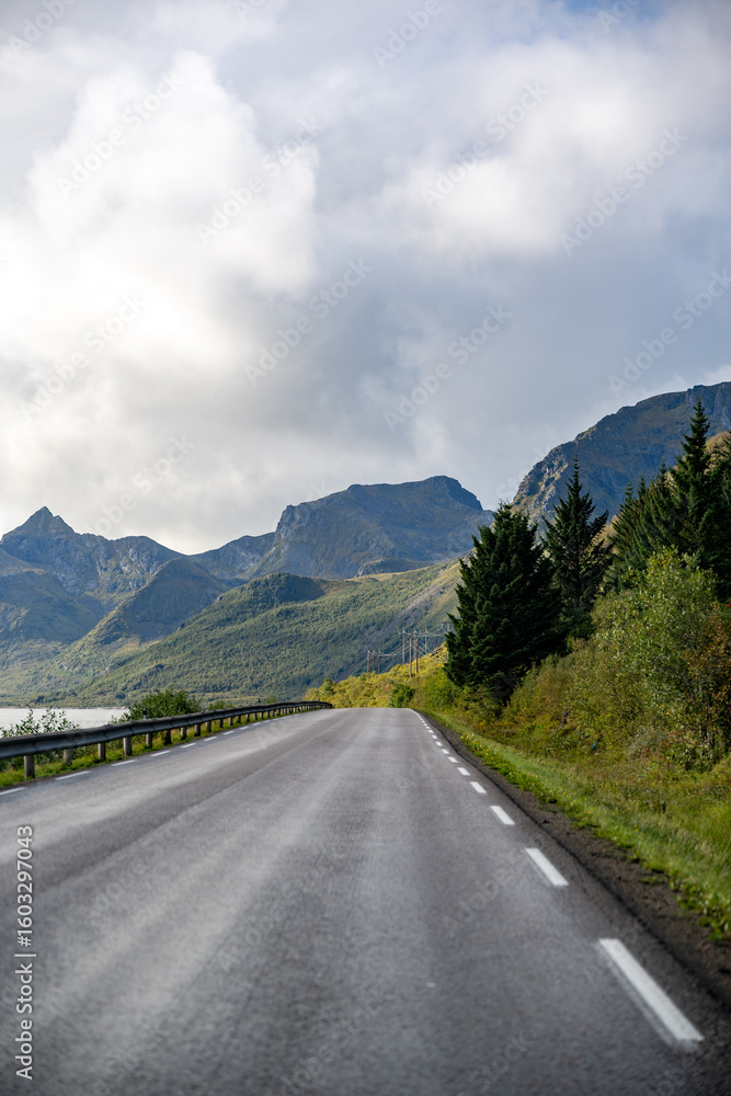 Fototapeta premium Scenic Coastal Road: Journey Through Majestic Mountains & Fjord Views – Perfect for Travel, Adventure & Nordic Landscapes