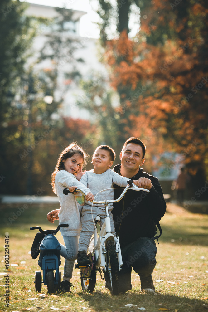 Happy family posing with bikes in autumn park Happy family posing with bikes in autumn park