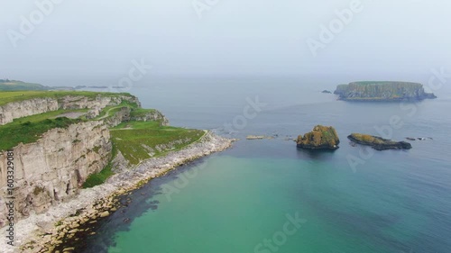 Aerial view on Cliffs and coast of Atlantic Ocean, Carrick a Rede Rope Bridge in Ballintoy, Northern Ireland. Drone Video