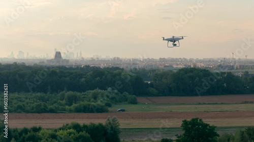 Aerial footage captured by a drone filming another drone high above the cityscape, showcasing stunning urban views and dynamic sky perspectives