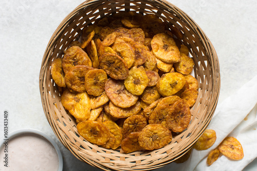 Overhead view of plantain chips, top view of fried ripe plantains on a white background