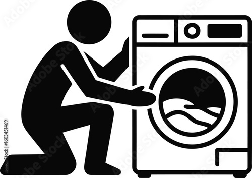 Person kneeling by a washing machine loading clothes