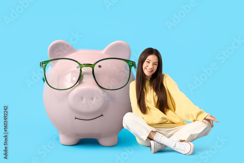 Piggy bank in eyeglasses on...