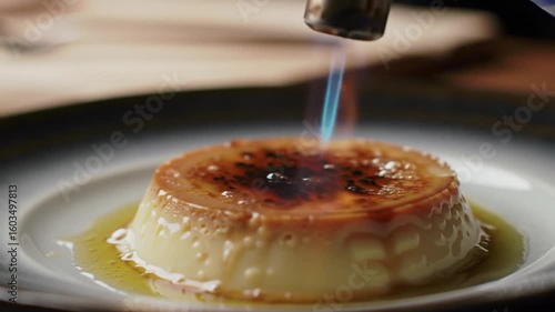 Crispy Crème Brûlée Being Caramelized By Culinary Torch In A Restaurant