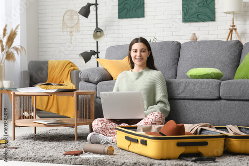 Young woman using laptop ne...