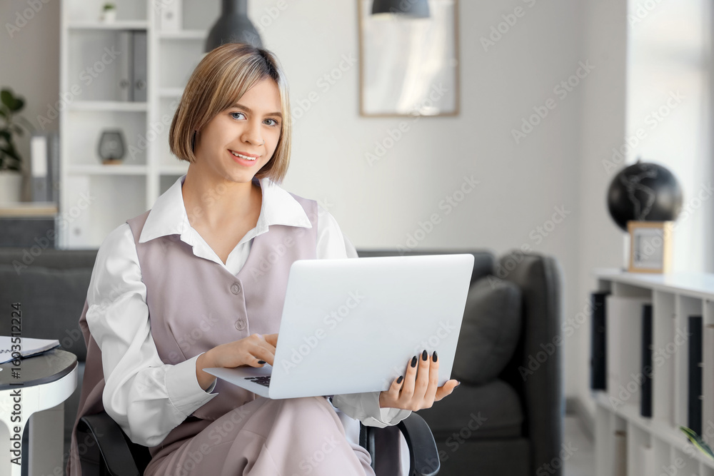Successful businesswoman using laptop in office Successful businesswoman using laptop in office