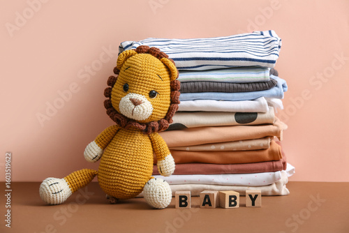 Stack of baby clothes with ...