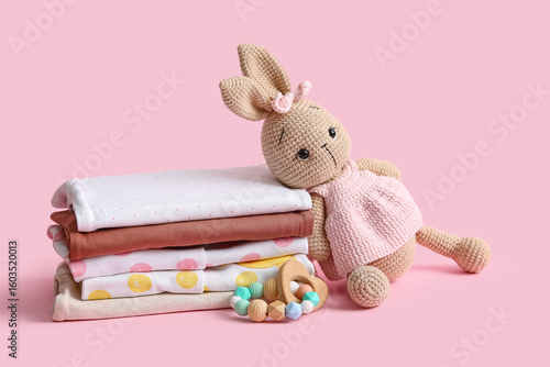 Stack of baby clothes with ...