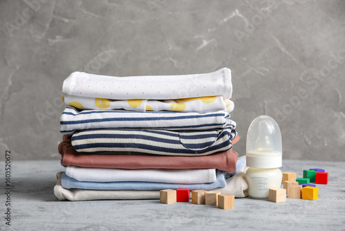 Stack of baby clothes with ...