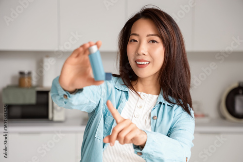 Happy young Asian woman poi...