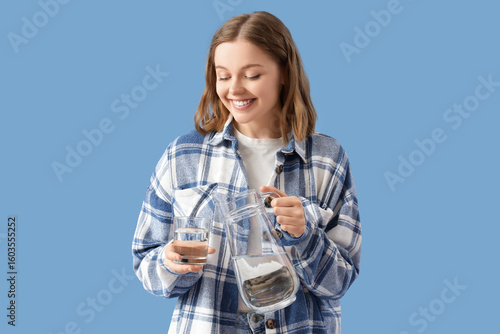 Young woman pouring water f...