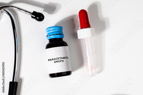 Tableau sur toile Essential medical items including a bottle of paracetamol drops and a stethoscope arranged on a doctor's desk, ideal for visuals related to treatment, consultation, or child healthcare