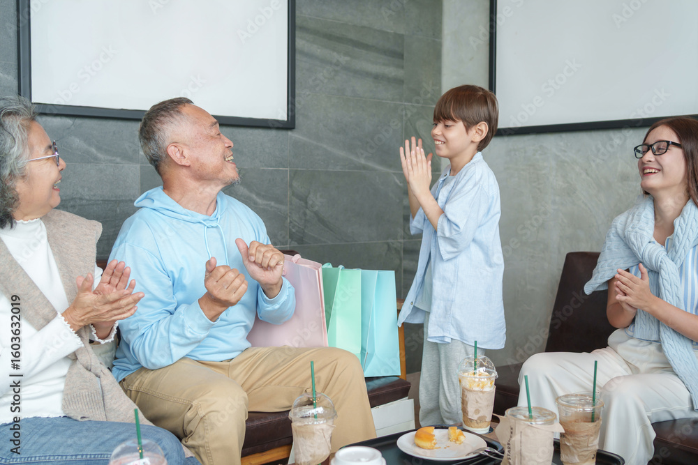 Fototapeta premium group of the generations family take a break coffee together at coffee shop,resting during travel,bonding grandson enjoy playing with grandfather