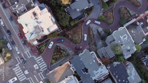 Timelapse of Lombard Street, known for its steep, one-block section with eight hairpin turns, in San Francisco, California, USA. Cars navigate the winding road.