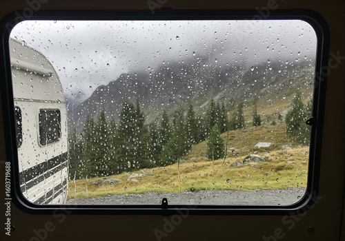 Rainy mountain vista from a camper van window