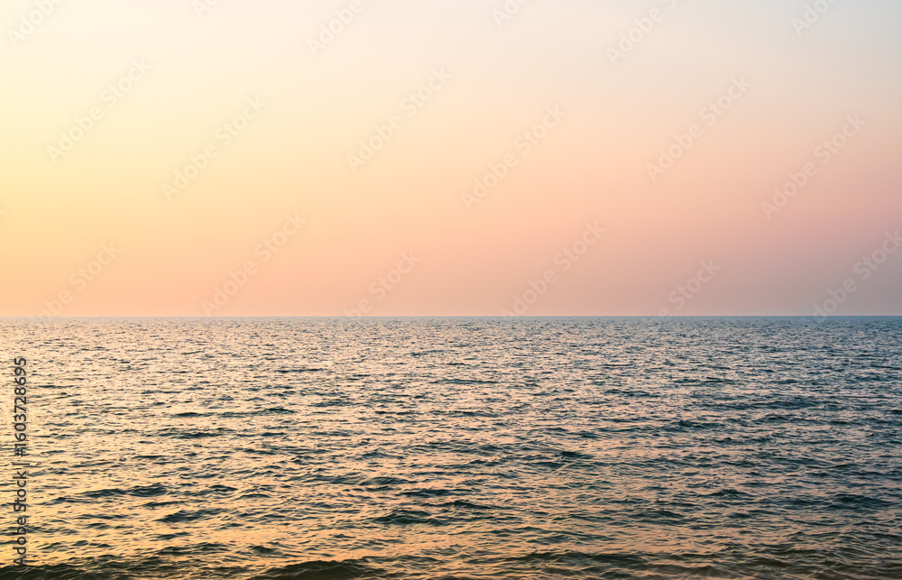 Obraz premium Sea sunset sky evening sunrise cloud weather dramatic landscape goldent and indigo color gradient pastel horizon, twilight yellow golden reflection morning nature environment energy ecosystem change.