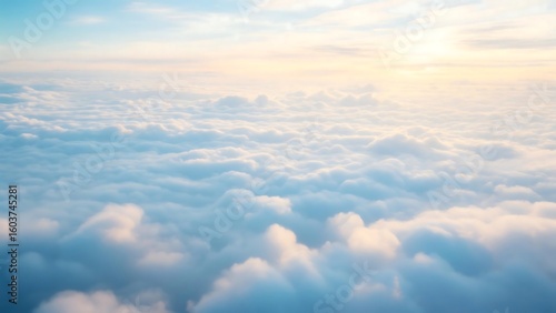 An aerial view showcases a sea of fluffy white clouds under a bright, sunny sky.