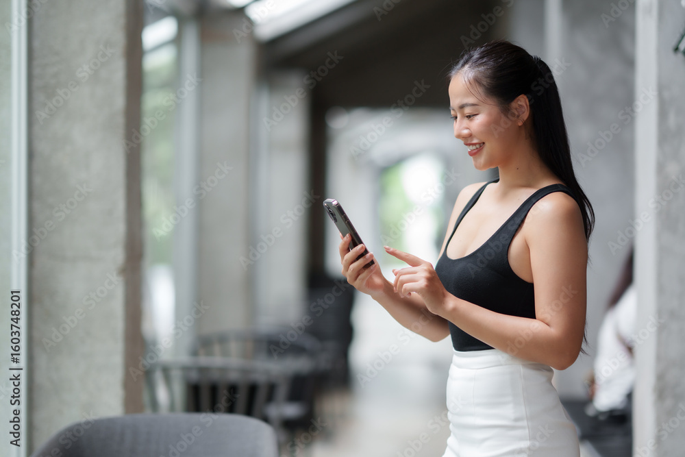 Young asian businesswoman using mobile phone in modern office building Young asian businesswoman using mobile phone in modern office building