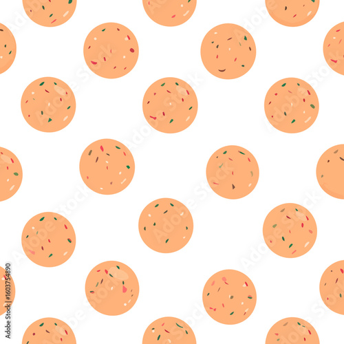 Round orange Indian Laddu sweets, a traditional dessert ball speckled with colorful red and green nut pieces.