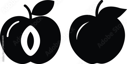 Black silhouette of two plums one cut open.