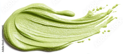 Swirls of vibrant green paste create a textured abstract pattern, evoking freshness and natural beauty against a clean backdrop.