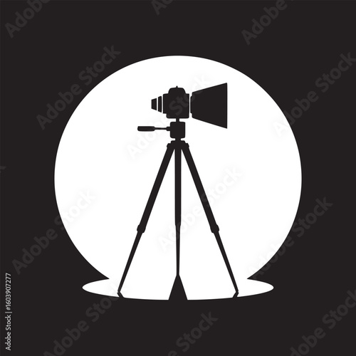 Silhouette of a camera on a tripod in front of a white circle against a black background image art
