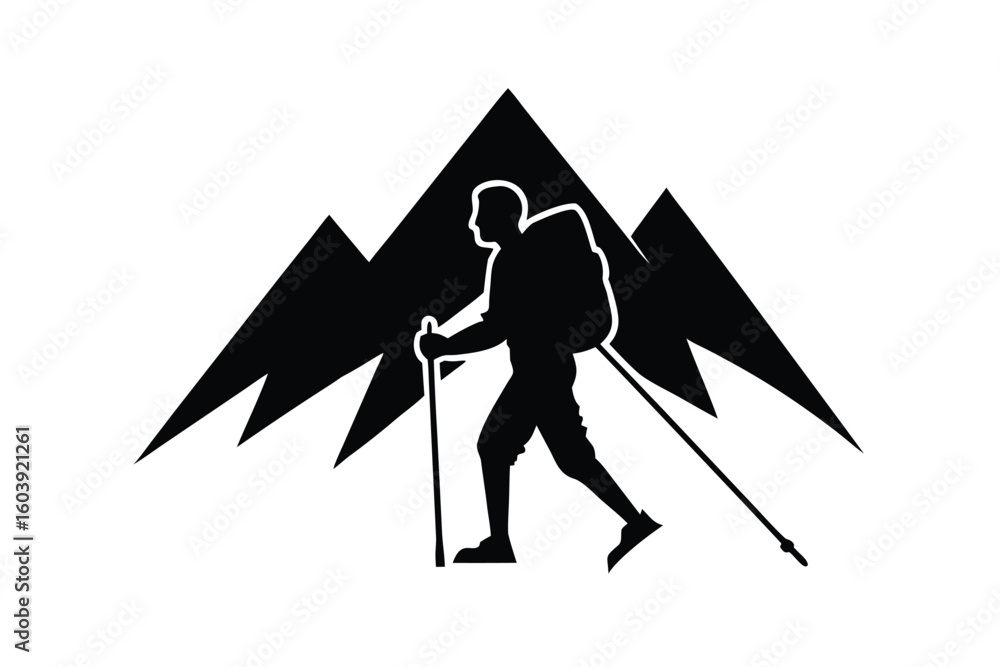 Fototapeta premium Silhouette of a hiker with trekking poles against jagged mountain peaks