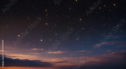 Starry night sky meeting clouds at sunset