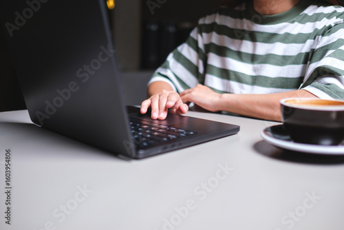 Closeup image of a businesswoman working and touching on laptop computer touchpad