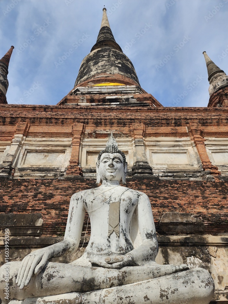 Fototapeta premium Thai Buddha Meditating against an Ancient Temple Ruins