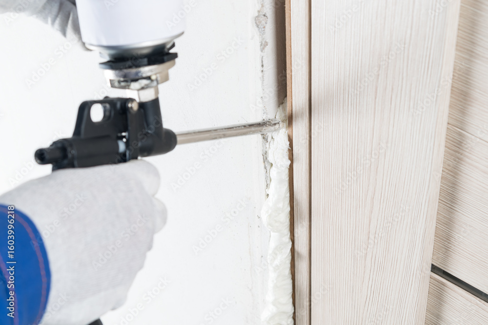 a gun for supplying mounting foam makes insulation of a doorway after installation by a master a gun for supplying mounting foam makes insulation of a doorway after installation by a master