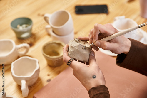 Fotografie Stylish man creates unique pottery in a vibrant ceramics studio filled with crea