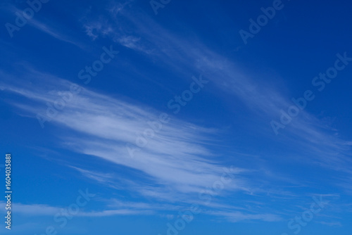 Fototapeta Naklejka Na Ścianę i Meble -  Blue summer sky with thin wispy clouds for use as a background texture
