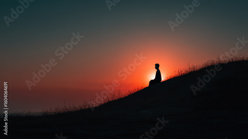 Meditating person enjoying the sunset on a hill, a moment of peace and reflection.