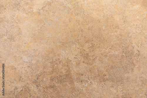 Background of textured brown surface showing natural patterns and light variations in a warm setting