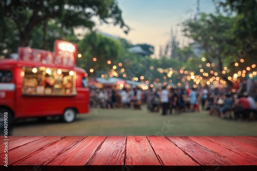 Red wooden table top, out-of-focus street food market
