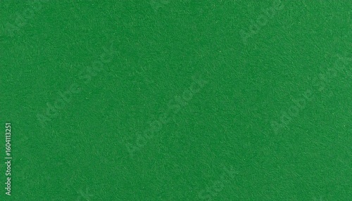 A solid green textured surface resembling felt fills the frame—evoking freshness, simplicity, and tactile calm through a minimal color and material study.