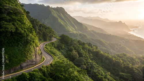 Winding Road Through Lush Mountains: A scenic road snakes through a vibrant mountain landscape, framed by lush, green vegetation, leading the eye towards the sun-kissed horizon.