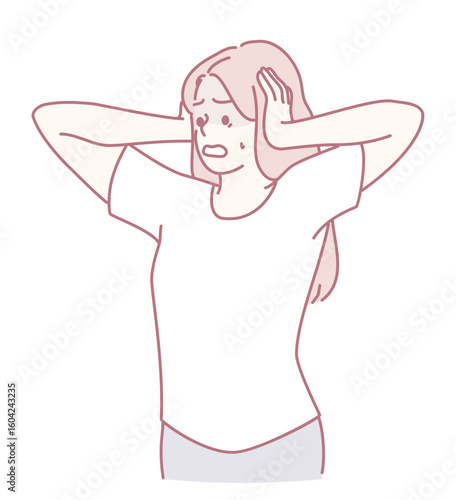 A woman is holding her head in visible distress, deeply conveying strong feelings of overwhelming stress and anxiety