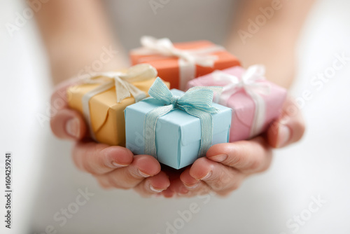 open hands holding beautifully wrapped gifts symbolize generosity and kindness during giving tuesday
