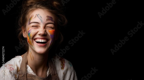 Smiling Woman with Face Painted Laughing on Black Background