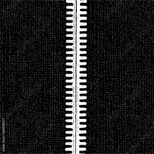 Close up view of a white zipper on a black fabric background showing the texture and detail of the zipper