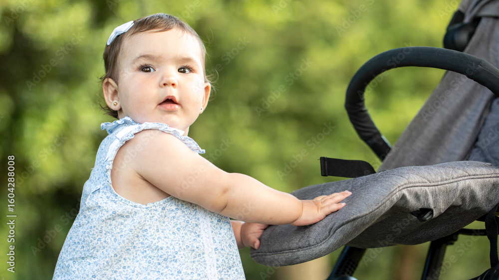 Obraz premium Baby in stroller outdoors in summer park