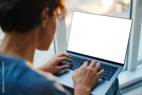 Person typing on laptop computer keyboard